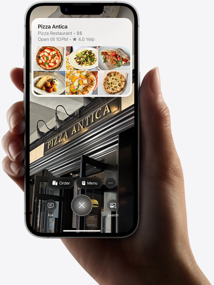 Käsi hoiab iPhone 16e mudelit, näitamas visuaalintellekti otsingu tulemusi.