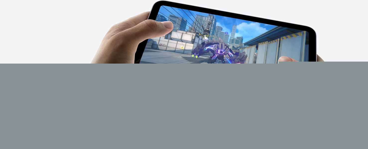 iPad mini held by a user's hands in landscape view playing a graphically intense game.