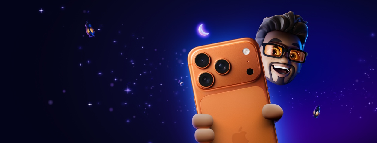 Memoji of a man with short brown hair and an extended goatee wearing thick black-framed glasses holding an iPhone 17 Pro in Cosmic Orange set against a starry purple gradient night sky with floating lanterns and a glowing crescent moon.