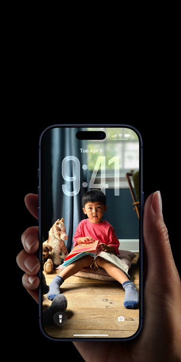 Hand holding iPhone 17 Pro, Message pop-up on personalized Lock Screen