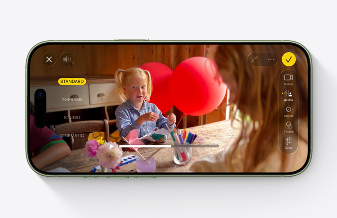 iPhone 17, front exterior, video with Audio Mix feature in use child playing at a table with balloons